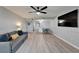 Bright and airy living room featuring modern decor, laminate flooring, and a ceiling fan at 1028 Apollo Beach Blvd # 21, Apollo Beach, FL 33572
