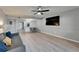 Bright and airy living room with modern decor, laminate flooring, a ceiling fan, and a large TV at 1028 Apollo Beach Blvd # 21, Apollo Beach, FL 33572