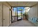 Enclosed patio with screened door, view of the canal, and tropical landscaping at 1028 Apollo Beach Blvd # 21, Apollo Beach, FL 33572