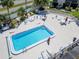 Overhead view of a sparkling community pool surrounded by lounge chairs and well-manicured landscaping at 1028 Apollo Beach Blvd # 21, Apollo Beach, FL 33572