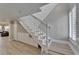 Elegant staircase with white banister, built-in storage, and wood-look flooring leads to the upper level of the home at 1028 Apollo Beach Blvd # 21, Apollo Beach, FL 33572
