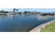 A serene waterfront view with boats docked along the canal and beautiful reflections on the calm water at 1028 Apollo Beach Blvd # 21, Apollo Beach, FL 33572