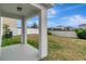 A covered back porch overlooking the backyard with a white fence at 1107 Seminole Sky Dr, Ruskin, FL 33570