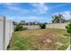 Expansive back yard featuring a white fence offering privacy and a blank canvas for landscaping and outdoor activities at 1107 Seminole Sky Dr, Ruskin, FL 33570