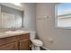Bathroom with vanity, sink, toilet, and window at 1107 Seminole Sky Dr, Ruskin, FL 33570