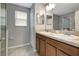 Bathroom featuring a double sink vanity with granite countertop and tile flooring at 1107 Seminole Sky Dr, Ruskin, FL 33570