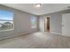 A bright bedroom with neutral walls, carpet, and a view from two large windows at 1107 Seminole Sky Dr, Ruskin, FL 33570