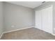 A bedroom features carpeting and a closet with bi-fold doors at 1107 Seminole Sky Dr, Ruskin, FL 33570