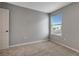 Neutral bedroom featuring carpeted flooring, a window with blinds, and a light gray wall color at 1107 Seminole Sky Dr, Ruskin, FL 33570