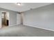 A bedroom features neutral walls, plush carpeting, and two entry doors at 1107 Seminole Sky Dr, Ruskin, FL 33570