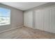Neutral bedroom with carpeted flooring, window with blinds and closet space at 1107 Seminole Sky Dr, Ruskin, FL 33570