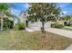 Two-story home with a two-car garage, landscaping, and a sidewalk at 1107 Seminole Sky Dr, Ruskin, FL 33570