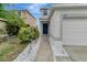 Charming home exterior featuring a striking blue front door and white rock landscaping at 1107 Seminole Sky Dr, Ruskin, FL 33570