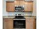 Kitchen with stainless steel oven and microwave, and light wood cabinetry at 1107 Seminole Sky Dr, Ruskin, FL 33570