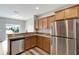 Kitchen featuring stainless steel appliances, granite counters, and wood cabinets at 1107 Seminole Sky Dr, Ruskin, FL 33570