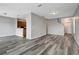 Open-concept living room with wood-look flooring and neutral walls at 1107 Seminole Sky Dr, Ruskin, FL 33570