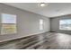 Bright, airy living room with wood-look flooring and neutral wall paint at 1107 Seminole Sky Dr, Ruskin, FL 33570