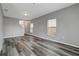Open living room featuring wood-look floors, staircase, and natural light at 1107 Seminole Sky Dr, Ruskin, FL 33570