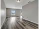 Spacious living room with wood-look flooring and bright, neutral paint at 1107 Seminole Sky Dr, Ruskin, FL 33570