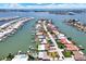 An aerial view shows waterfront homes with docks and boats lining the shoreline at 11628 Grove St, Seminole, FL 33772