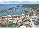 Gorgeous aerial view of waterfront homes, canal access, and blue skies in a beautiful coastal community at 11628 Grove St, Seminole, FL 33772