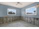 Bedroom remodel with windows showing outside scenery, ready for flooring and paint at 11628 Grove St, Seminole, FL 33772