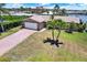 An aerial view of a house with brick driveway and two palm trees in the front yard at 11628 Grove St, Seminole, FL 33772