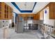Kitchen remodel with stainless steel refrigerator, light wood cabinetry, and view to the open living space at 11628 Grove St, Seminole, FL 33772