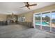 Great room showcasing fireplace, sliding glass doors to pool area, and an open canvas for future design at 11628 Grove St, Seminole, FL 33772