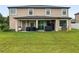 Expansive backyard with a covered patio, perfect for outdoor entertaining and relaxation at 11706 Gilmerton Dr, Riverview, FL 33579