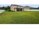 Large backyard with lush green grass and a white fence, creating a private and serene outdoor space at 11706 Gilmerton Dr, Riverview, FL 33579