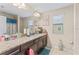 Well-lit bathroom with granite counters, a wide mirror, and tile flooring at 11706 Gilmerton Dr, Riverview, FL 33579