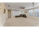 Spacious bonus room featuring a ceiling fan, projector screen, and multiple windows at 11706 Gilmerton Dr, Riverview, FL 33579