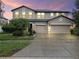 Charming two-story home with landscaped yard and a large two car garage and wide driveway at 11706 Gilmerton Dr, Riverview, FL 33579