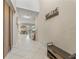 Bright foyer with tile flooring, bench and coat rack at 11706 Gilmerton Dr, Riverview, FL 33579