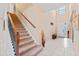 Grand staircase leads to a light-filled foyer with tile flooring and high ceilings at 11706 Gilmerton Dr, Riverview, FL 33579
