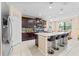 Modern kitchen features granite counters, stainless steel appliances, and a breakfast bar with seating at 11706 Gilmerton Dr, Riverview, FL 33579