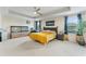 Bright main bedroom with tray ceiling, ceiling fan, plush carpet, and large window at 11706 Gilmerton Dr, Riverview, FL 33579