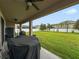 Covered patio with fans overlooks a spacious backyard enclosed by a white fence at 11706 Gilmerton Dr, Riverview, FL 33579