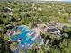 Aerial view of a sparkling community pool surrounded by lush landscaping and palm trees at 11706 Gilmerton Dr, Riverview, FL 33579