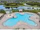Aerial view of a beautiful community pool and splash pad near a lake at 11706 Gilmerton Dr, Riverview, FL 33579