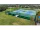 Outdoor community tennis court surrounded by green lawns at 11706 Gilmerton Dr, Riverview, FL 33579