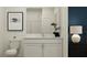Bathroom featuring a dual-sink vanity, a wall to wall mirror, and a modern toilet, perfect for a growing Gathering at 11761 E 71St Ter, Palmetto, FL 34221
