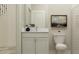 Well-lit half bathroom with neutral-toned walls, a modern vanity, an elegant mirror, and a low flow toilet at 11761 E 71St Ter, Palmetto, FL 34221
