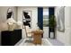 Well-lit home office featuring a modern desk, stylish lamp, black and white artwork, and plush decor for a productive workspace at 11761 E 71St Ter, Palmetto, FL 34221