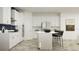 Modern kitchen featuring a kitchen island, a stainless steel fridge, white cabinets, and stainless steel appliances at 11761 E 71St Ter, Palmetto, FL 34221