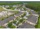 Aerial view of a complex of well-maintained townhomes next to community pool and wooded areas at 11903 Greengate Dr, Hudson, FL 34669