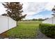 View of the backyard, showcasing green space and a partial fence at 11903 Greengate Dr, Hudson, FL 34669