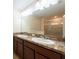 Double sink bathroom vanity with granite countertops and modern lighting at 11903 Greengate Dr, Hudson, FL 34669