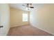 Neutral bedroom featuring carpet, a ceiling fan, and a bright window at 11903 Greengate Dr, Hudson, FL 34669
